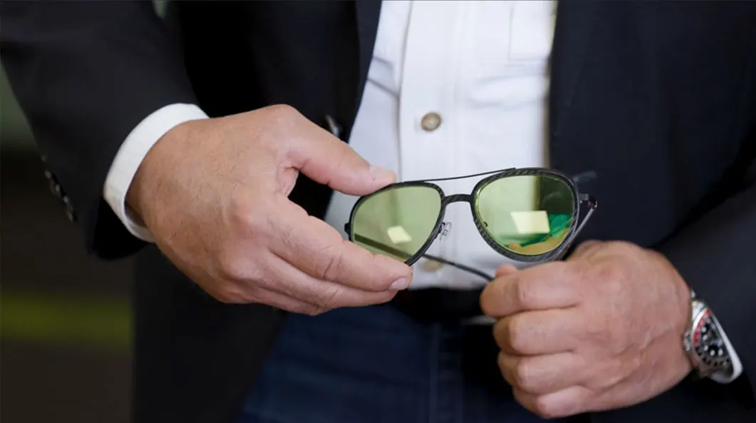 Interface eyewear man holding glasses